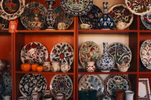 Collection of colorful İznik ceramics on display shelves in Bursa, showcasing traditional Turkish art.