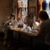 Artists hand-paint intricate designs on ceramics in a sunlit workshop in Bursa, Türkiye.