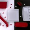 A stylish flat lay of red and white porcelain tableware on contrasting backgrounds, perfect for modern decor.