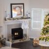 Warm and inviting living room decorated for Christmas with a beautifully lit tree and fireplace.