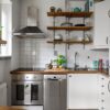 Contemporary small kitchen featuring stainless steel appliances and open shelving.